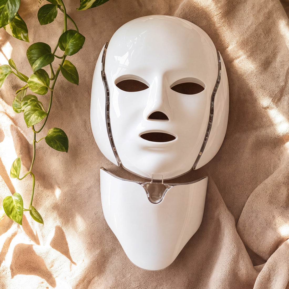 NeoTelle Spectra LED face mask and neck plate on warm beige cloth