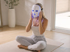 Woman wearing the NeoTelle LED light therapy mask during a calm at-home session